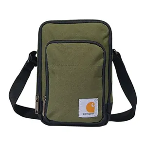 A green shoulder bag with black trim and a front pocket, featuring a Carhartt logo. It has two zippered compartments and an adjustable black strap.