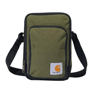 A green shoulder bag with black trim and a front pocket, featuring a Carhartt logo. It has two zippered compartments and an adjustable black strap.