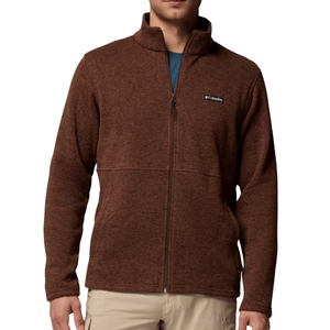 Brown full-zip fleece jacket with a logo on the chest, paired with beige pants.