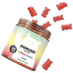 90 gummy bear-shaped immune support supplements are shown spilling from a jar labeled \“vegan\“ with vitamins C, D, E, B3, B5, B6, B7, B9, and B12.