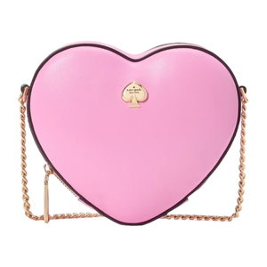 A heart-shaped crossbody bag in pink leather with a gold chain strap and a small gold spade logo on the front.
