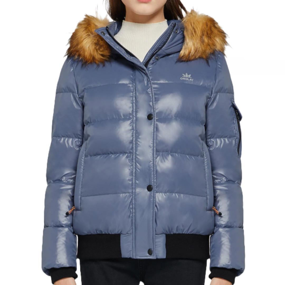 Blue puffer jacket with fur-trimmed hood, black cuffs, and button closure. Features zippered side pocket and branding on the chest.