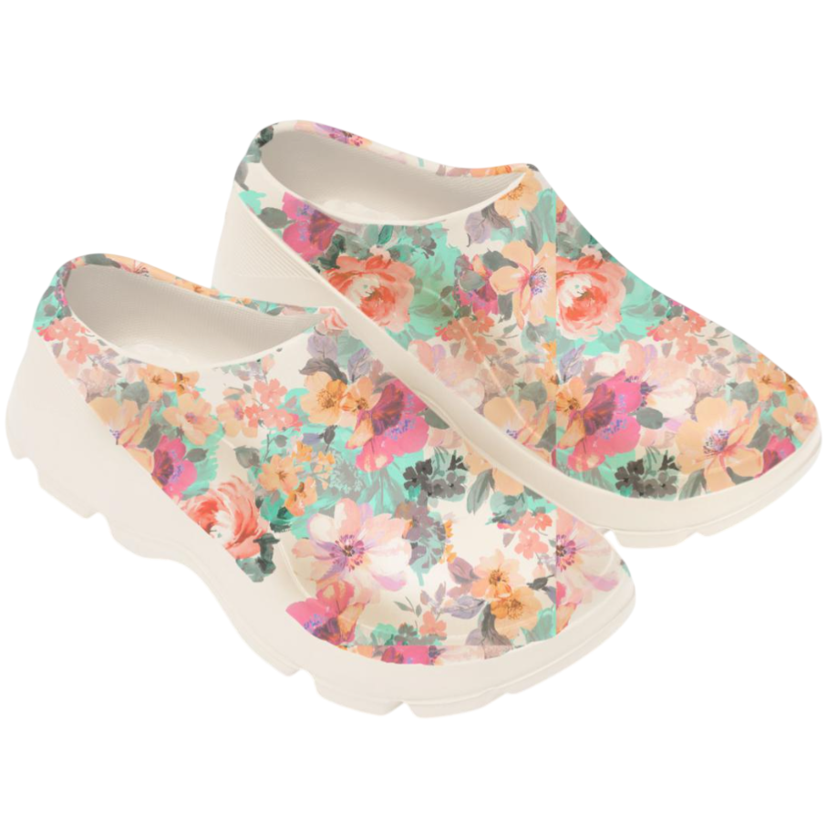 Floral-patterned slip-on shoes with a sturdy white sole, featuring vibrant colors like pink, orange, and teal.