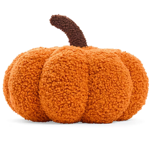 A plush orange pumpkin-shaped pillow with a textured, soft surface and a dark brown stem.