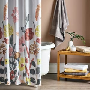 Floral shower curtain featuring a watercolor-style design with pink, yellow, and earthy tones, complementing a neutral bathroom setting.