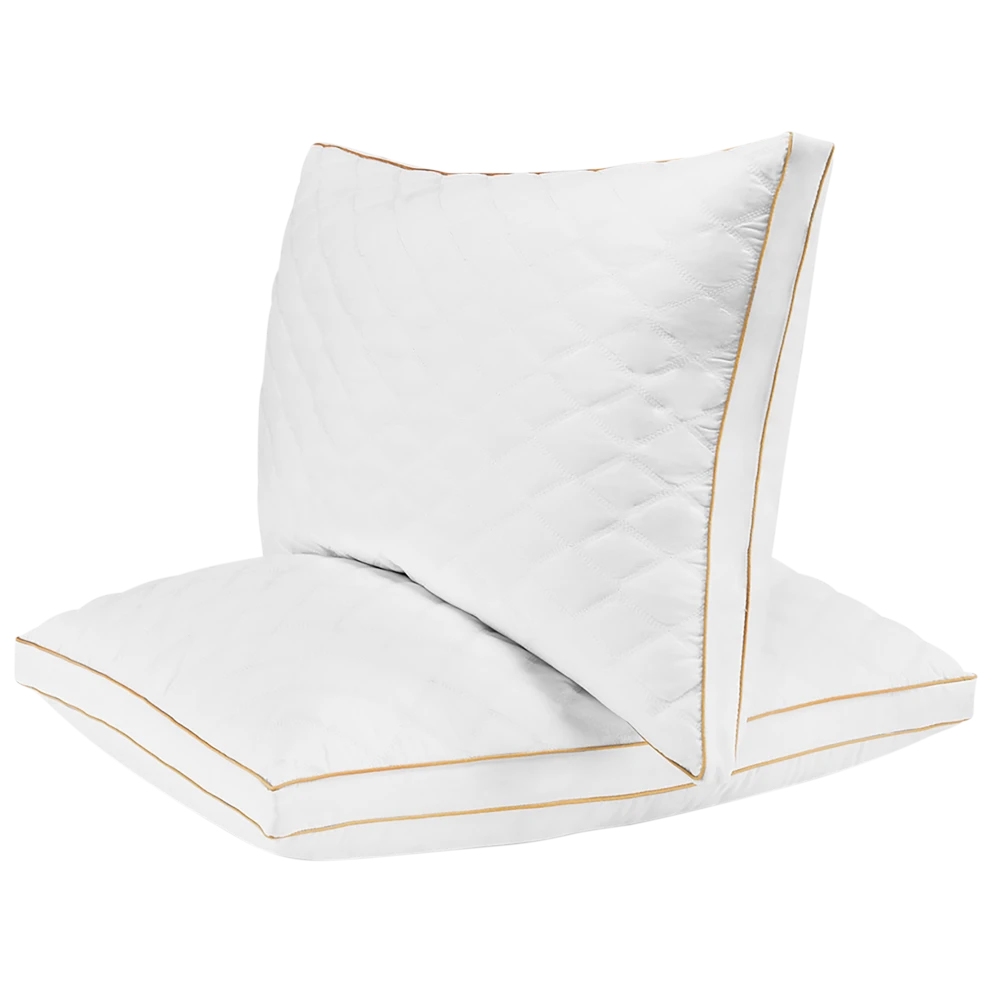 Two quilted white memory foam king pillows with gold piping detail.