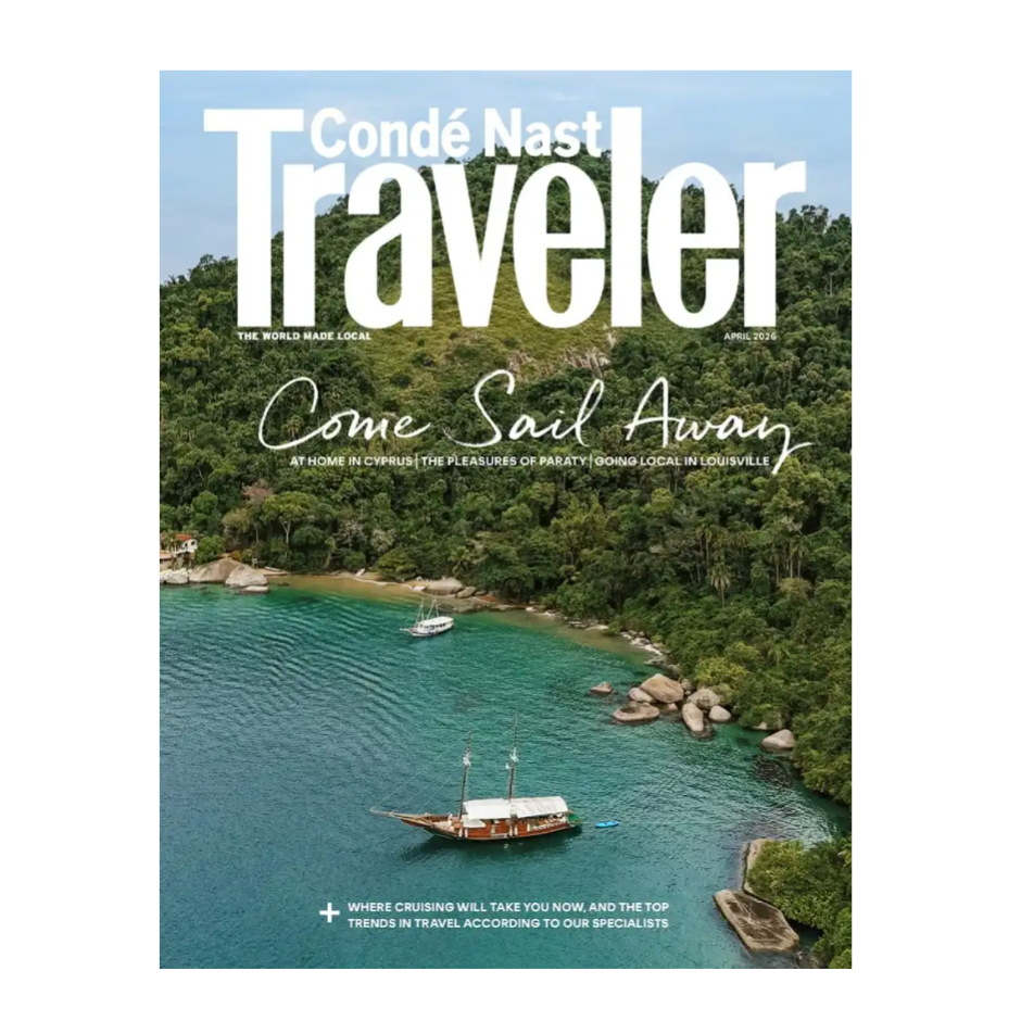 Cover of Condé Nast Traveler magazine, April 2026, featuring a scenic view of a sailboat in a tropical bay surrounded by lush greenery.