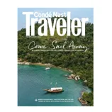 Cover of Condé Nast Traveler magazine, April 2026, featuring a scenic view of a sailboat in a tropical bay surrounded by lush greenery.