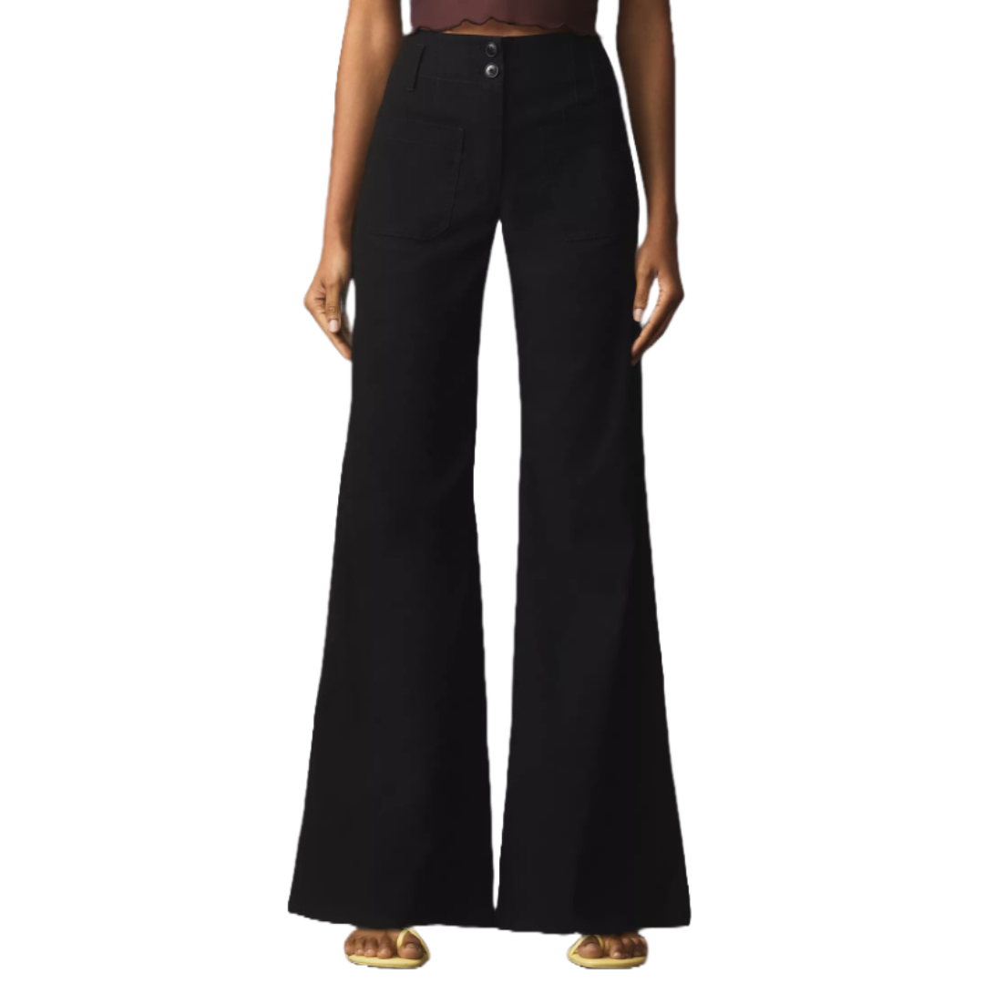 High-rise, black flared pants with large front pockets, two-button closure, and hemline reaching the floor, paired with gold sandals.
