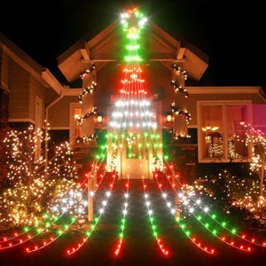 Christmas star string lights form a large tree shape on a house front, featuring red, white, and green lights with a star at the top. The lights create a festive, welcoming display, illuminating the porch and surrounding area with holiday cheer.
