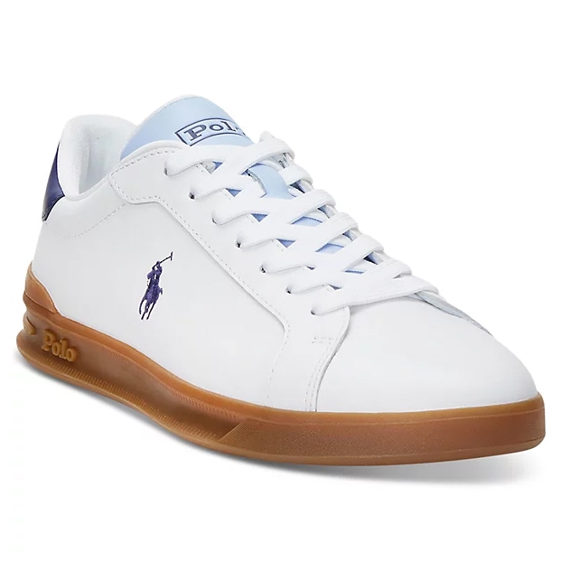 White low-top sneaker with a blue logo of a horse rider on the side, matching blue details on the tongue and heel, and brown gum sole.
