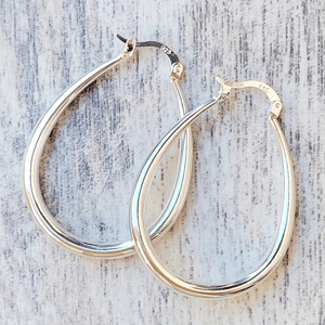 Silver teardrop hoop earrings with latch-back closures, marked \“925\“ for sterling silver.