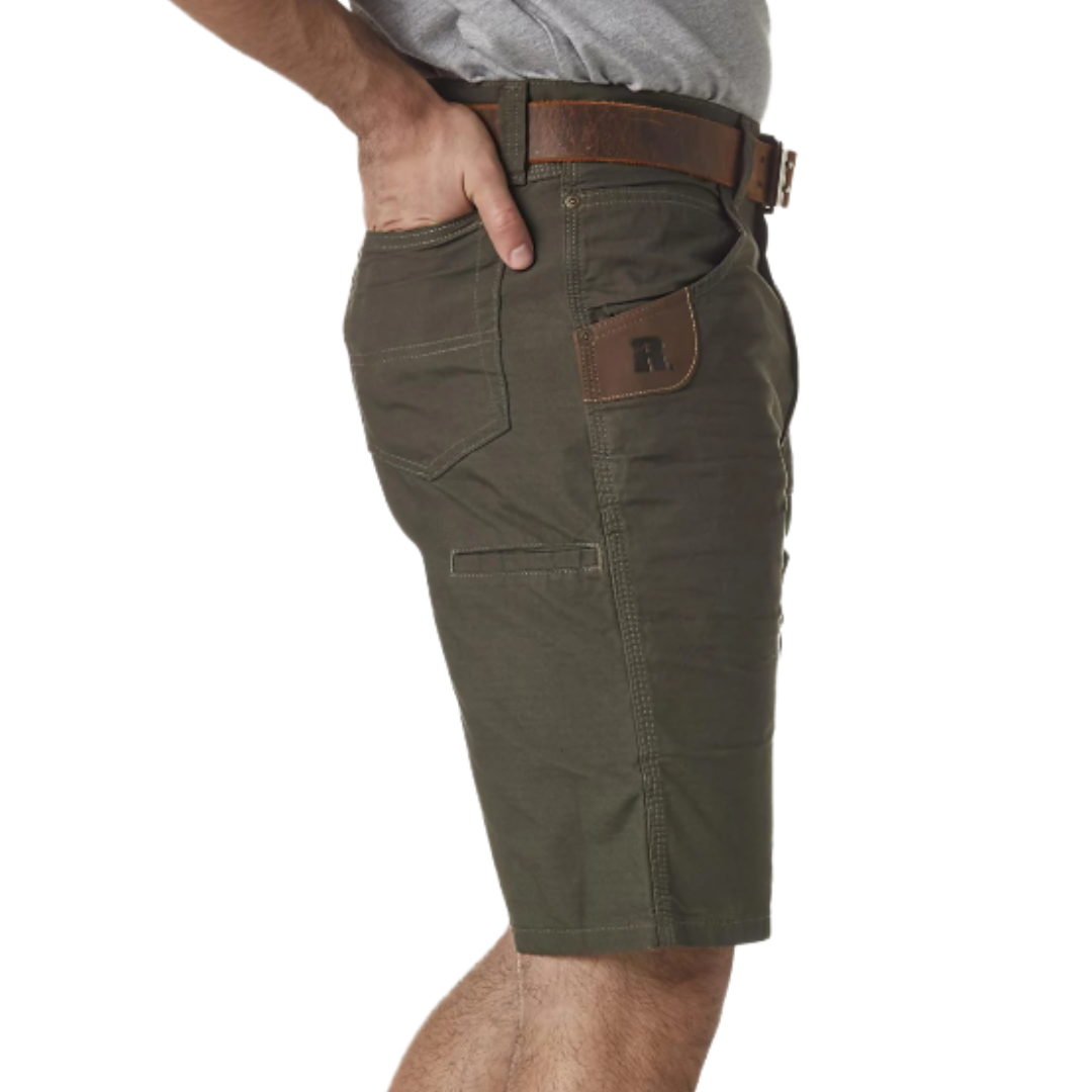 A person wearing olive green cargo shorts with a brown belt and a gray T-shirt, showing a side pocket with a leather accent.