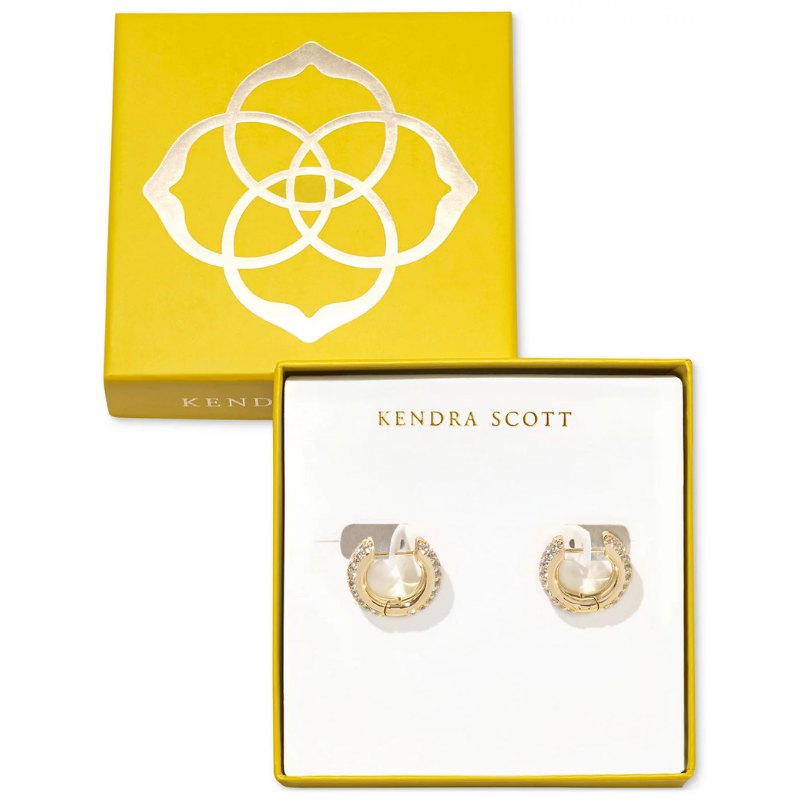 Kendra Scott Huggie Hoop Earrings feature a gold-plated design with embedded crystals, presented in a signature yellow box with a floral logo.