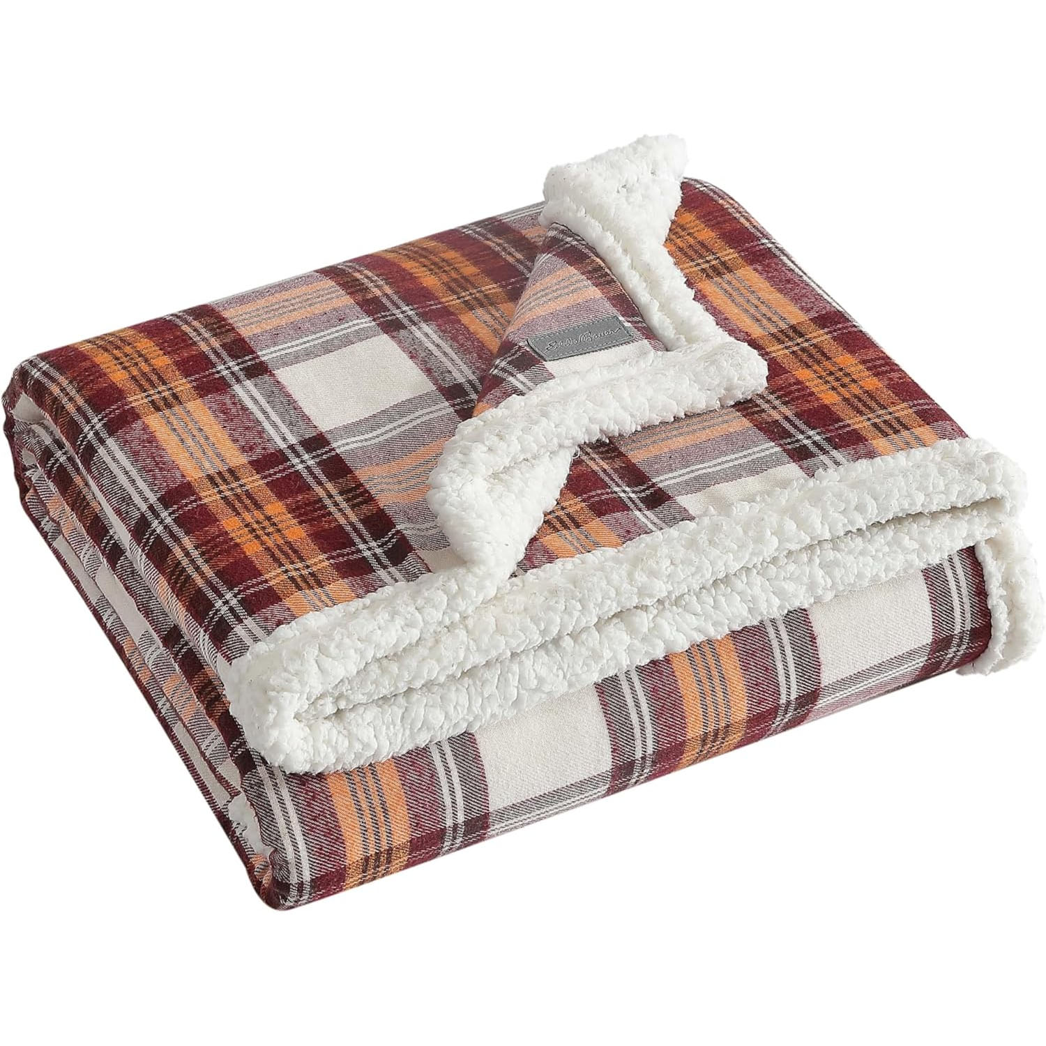 A folded plaid fleece blanket with a red, orange, and white checkered pattern, featuring a white sherpa lining.