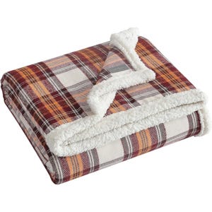 A folded plaid fleece blanket with a red, orange, and white checkered pattern, featuring a white sherpa lining.