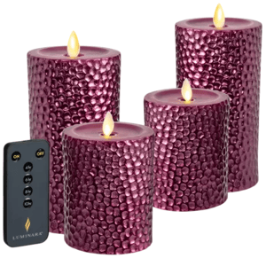 A set of four purple textured flameless LED candles with a remote control, showcasing lifelike faux flames.