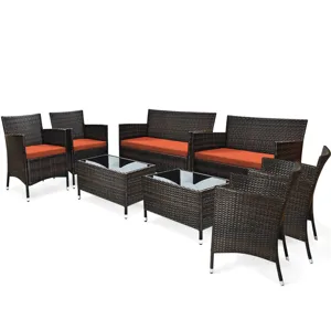 Outdoor patio furniture set including four chairs, two loveseats, and two glass-top coffee tables in dark wicker with orange cushions.