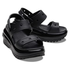 Black Crocs Mega Crush Sandals feature a chunky platform sole with multiple circular holes on the straps for ventilation. The design includes adjustable back straps and a textured footbed for comfort.
