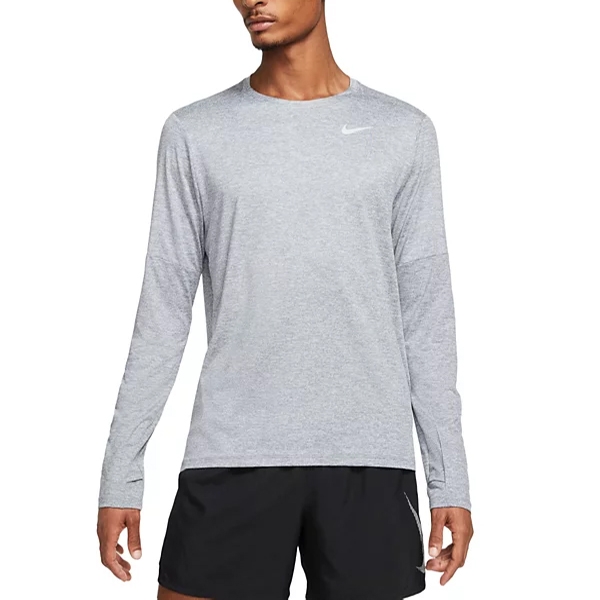 Nike Men's Dri-FIT Tee is a long-sleeve, light gray shirt with a small Nike logo on the left chest, designed for athletic use. It's paired with black shorts, suitable for running or training activities.