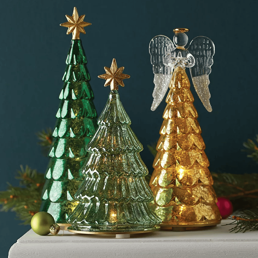 A green glass Christmas tree with an LED light feature, topped with a gold star, measuring 9 inches in height.