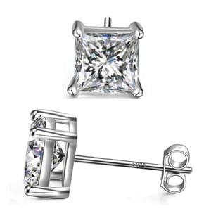 Silver square stud earrings feature a large, clear square-cut gemstone set in a four-prong setting. The post is marked with \“925,\“ indicating sterling silver.