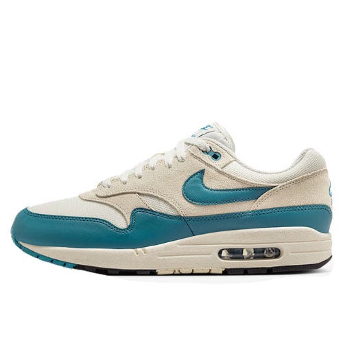A pair of Nike Air Max 1 sneakers with a beige and teal color scheme, featuring a visible Air unit in the sole.