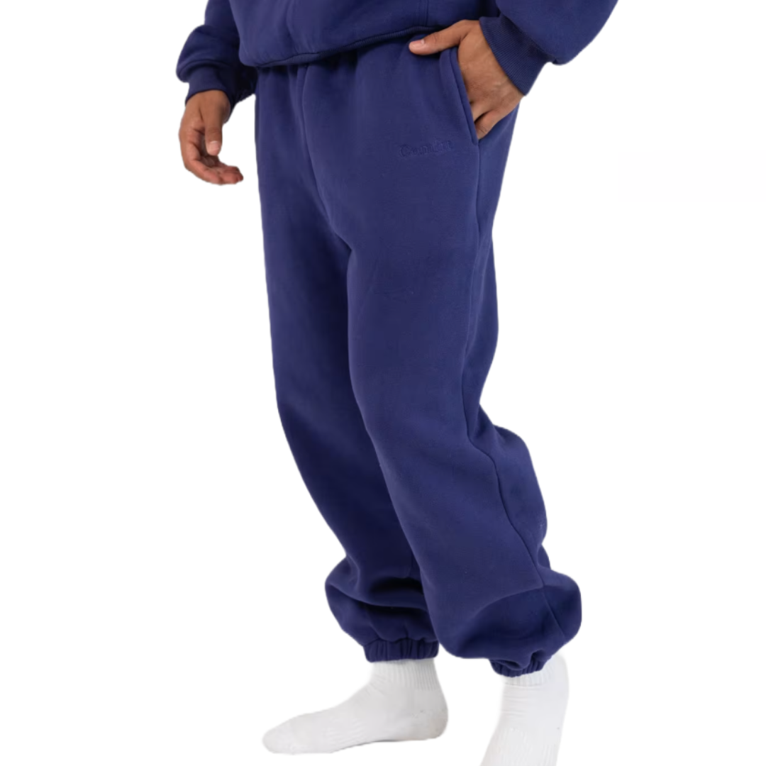 Blue fleece sweatpants with an elastic waistband and cuffs, featuring side pockets and a relaxed fit.