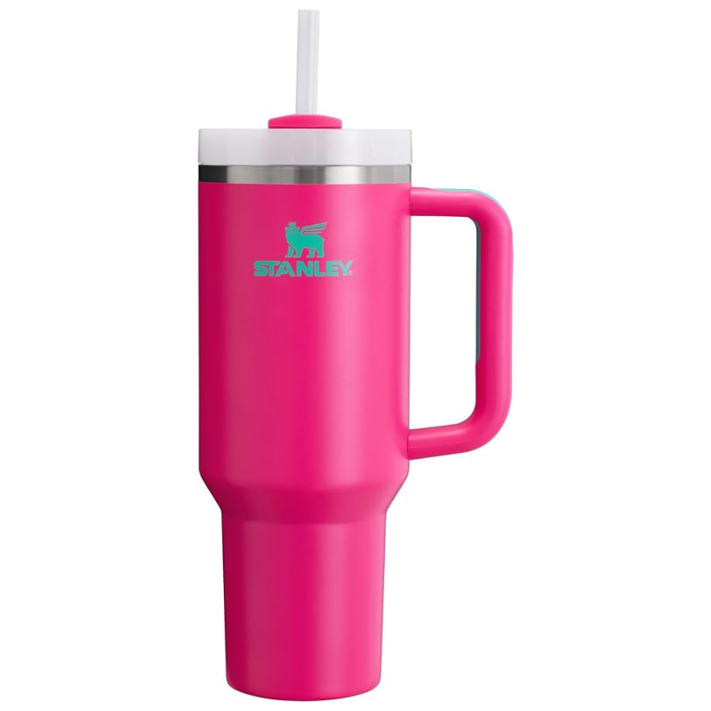 A bright pink Stanley tumbler with a handle and straw, featuring a stainless steel rim and turquoise logo.