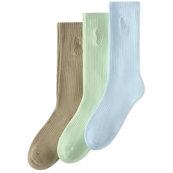 A set of three ribbed socks in beige, mint green, and light blue, each featuring a subtle embroidered logo near the top.