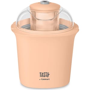 Peach-colored Tasty by Cuisinart 1.5qt ice cream maker with a transparent lid and a central mixing paddle.