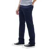 A person is wearing navy blue corduroy pants paired with black and white sneakers and a gray sweater.