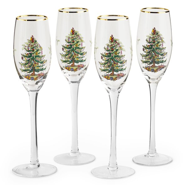 Set of four Spode Christmas champagne glasses featuring a festive Christmas tree design and gold rims, perfect for holiday celebrations.