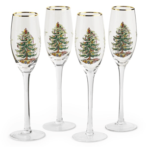 Set of four Spode Christmas champagne glasses featuring a festive Christmas tree design and gold rims, perfect for holiday celebrations.