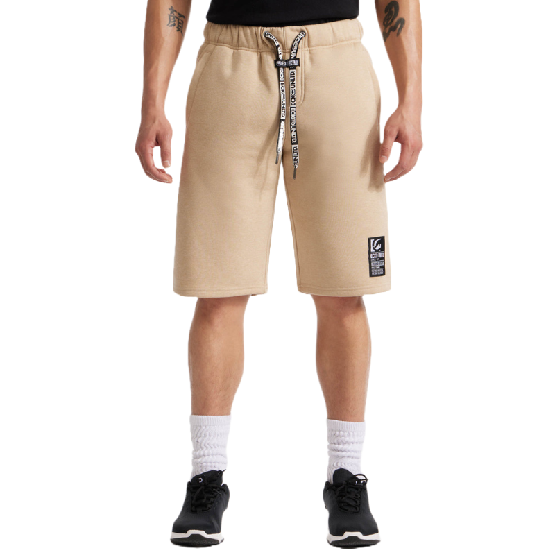 Beige knee-length shorts with black drawstrings, white socks, and black sneakers.