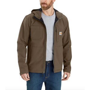 Men's brown hooded softshell jacket with a front zip, chest pocket, and Carhartt logo on the left chest. It's paired with a gray shirt and blue jeans.