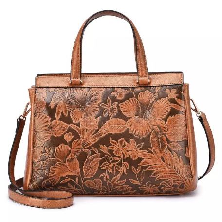 A brown leather handbag with floral embossing, featuring short handles and a detachable long strap for versatile carrying options.