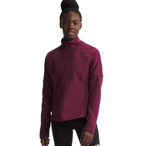 Person wearing a maroon quarter-zip fleece pullover and black leggings with The North Face logo.