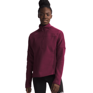 Person wearing a maroon quarter-zip fleece pullover and black leggings with The North Face logo.