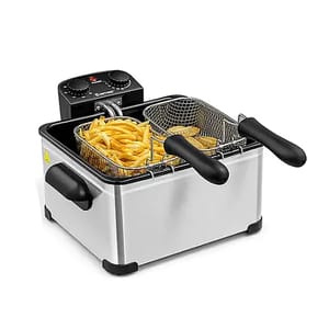 A stainless steel deep fryer with dual mesh baskets containing fries and another fried item, featuring temperature control knobs and heat indicators.