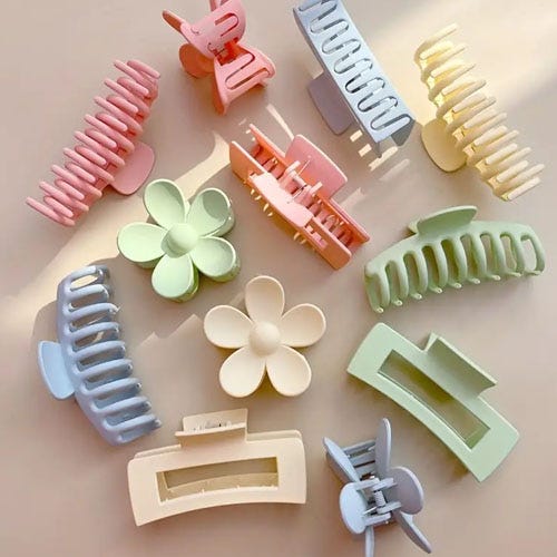 Various hair clips in different shapes and pastel colors, including rectangular, round-edged, and flower designs.