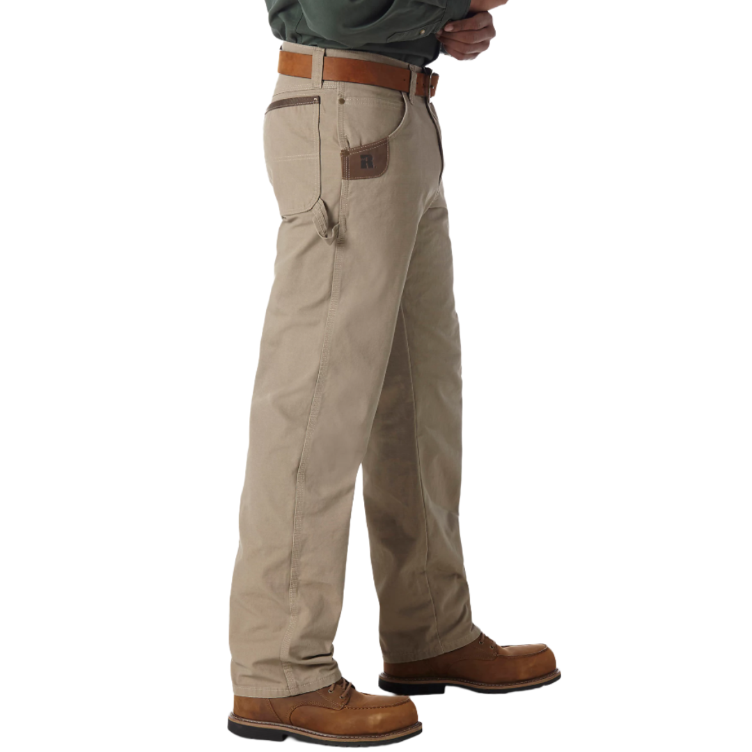 Tan work pants with a leather belt, featuring reinforced pockets and a loop for tools, paired with brown leather boots.