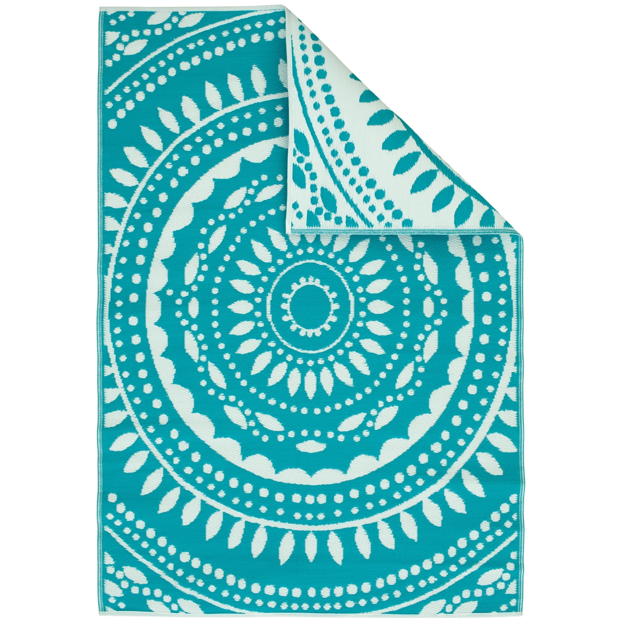 A turquoise and white patterned beach towel with mandala design.