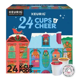 Keurig 24 K-Cup Pods holiday-themed box labeled \“24 Cups of Cheer,\“ featuring a festive house design with Christmas decorations and a snowman. Includes flavors like Original Donut Shop Peppermint Bark and McCafé.