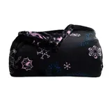 A black fleece blanket featuring pink and blue snowflake patterns, folded neatly.