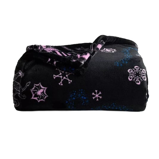 A black fleece blanket featuring pink and blue snowflake patterns, folded neatly.