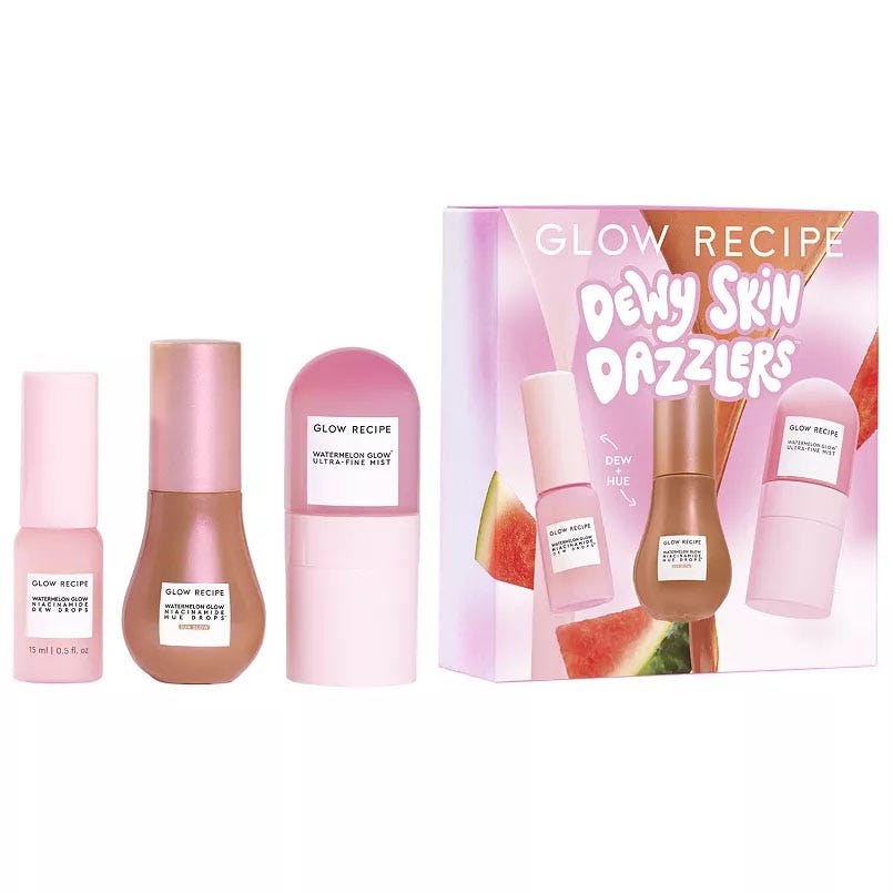 Glow Recipe Dewy Skin Dazzlers Kit includes a 15 ml dewdrop facial serum, bronzing drop illuminator, and ultra-fine watermelon mist. The packaging is pink with a watermelon theme.