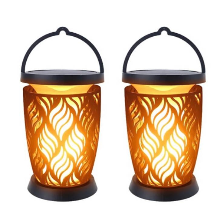 Two solar-powered torches with flame-patterned cutouts and a handle on top for hanging.