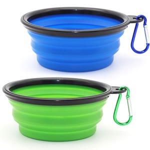 Two collapsible silicone bowls in blue and green, each with a black rim and an attached carabiner.