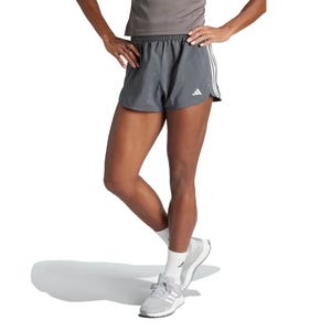 Gray athletic shorts with white stripes, paired with gray running shoes and white socks.